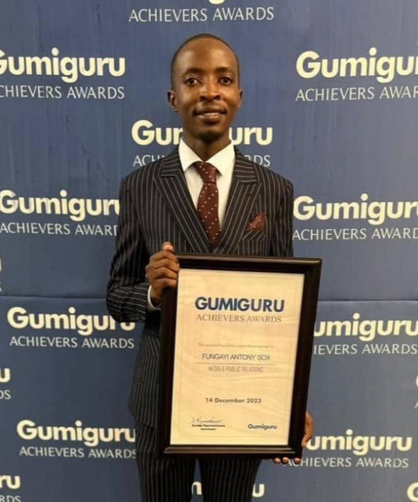 Fungayi Antony Sox holding his Gumiguru Achievers Award for Media and Public Relations, December 2023.