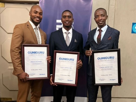 Fungayi Antony Sox with fellow Gumiguru Achievers Award winners holding their certificates.