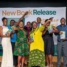 Guests raising copies of Entrepreneurial Success beneath a New Book Release banner.